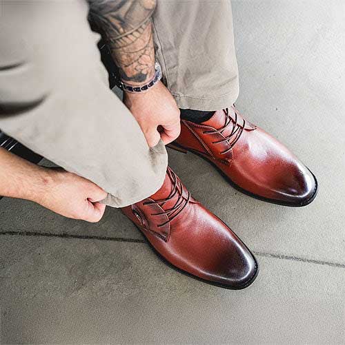 Top View of Man in Light Pants Straightening his Domani Elevator Boots
