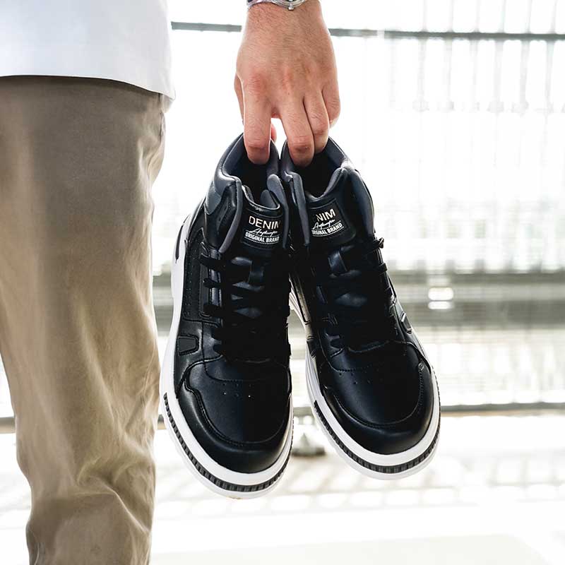 Man Standing Holding Apex Elevator Sneakers