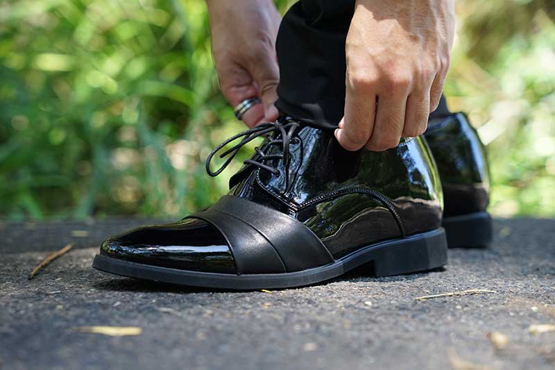 Man Tying Laces of Ashford Elevator Dress Shoes