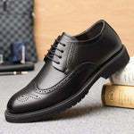 Benedikt Elevator Brogue in Black Resting on Books | Levante Shoes