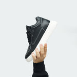 Man Holding Up Novo Black Elevator Sneaker | Levante Shoes