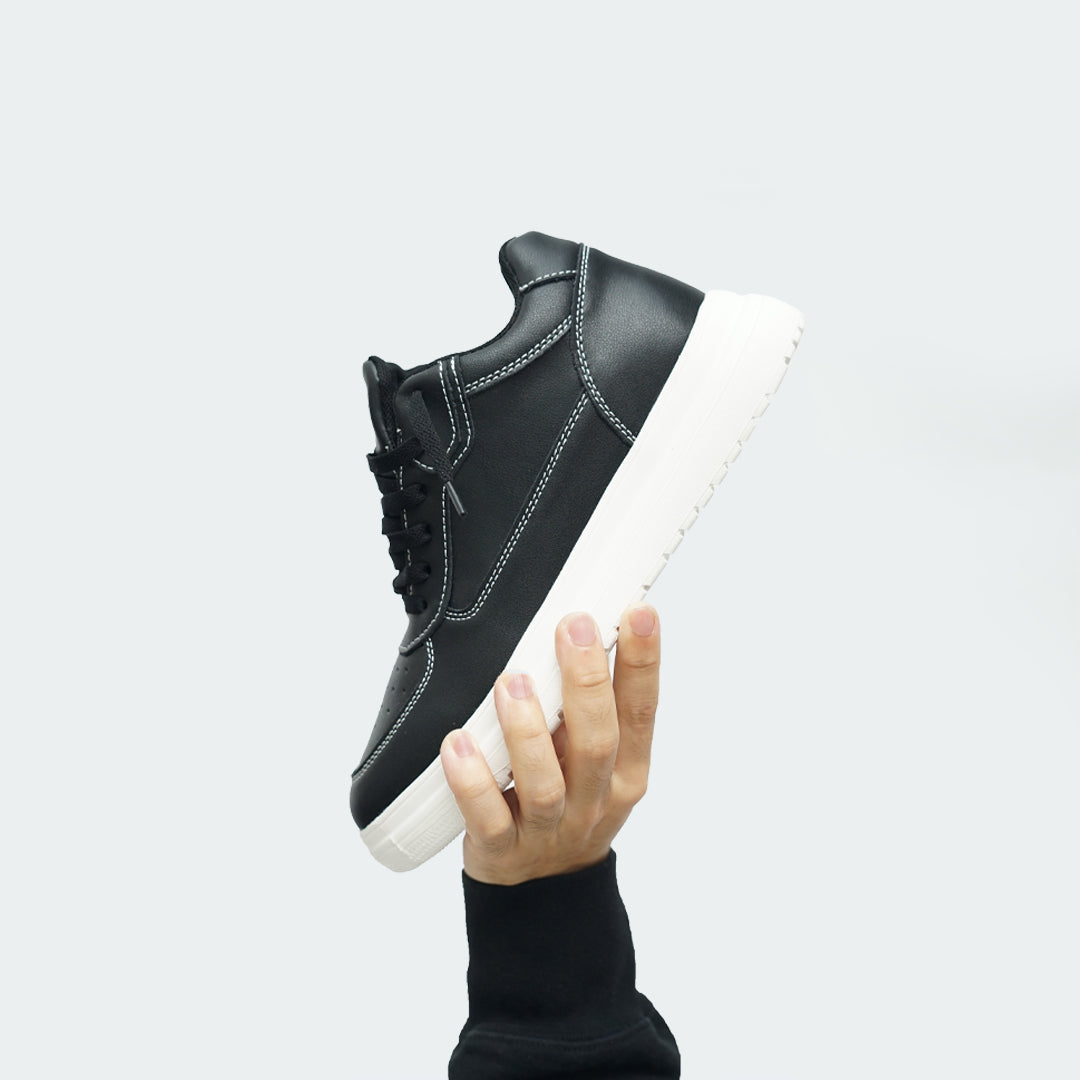 Man Holding Up Novo Black Elevator Sneaker | Levante Shoes