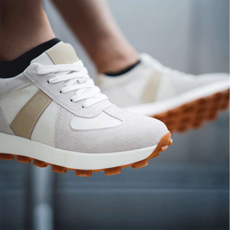 Close Up of Man Wearing Camden Elevator Sneakers Sitting on Ledge | Levante Shoes