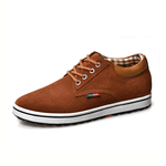 Brown casual shoe with a white sole on a white background
