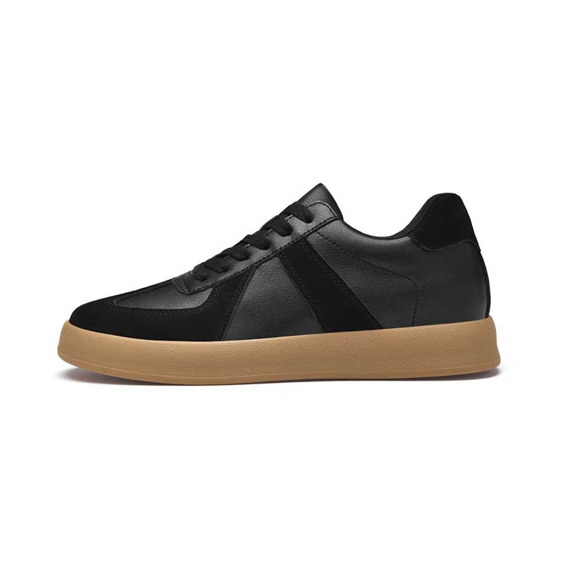 Black sneaker with a brown sole on a white background