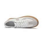 White sneaker with brown sole on a white background