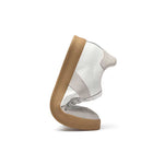 White sneaker with brown sole on a white background