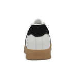 White sneaker with black side panel and brown sole on a white background