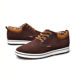 Brown casual shoes with white soles on a white background