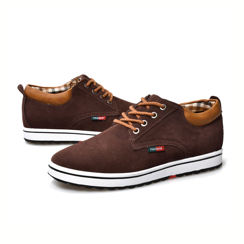 Brown casual shoes with white soles on a white background