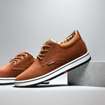 Brown shoes with white soles on a gray background