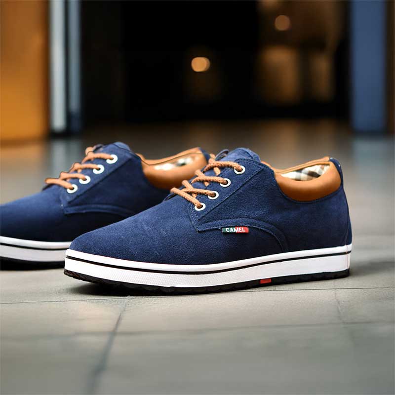Blue casual shoes with brown accents on a tiled floor