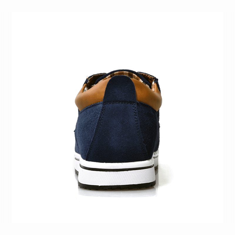 Navy blue sneaker with brown accents on a white background
