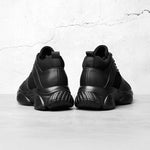 Black high-top elevator sneakers on a light grey background