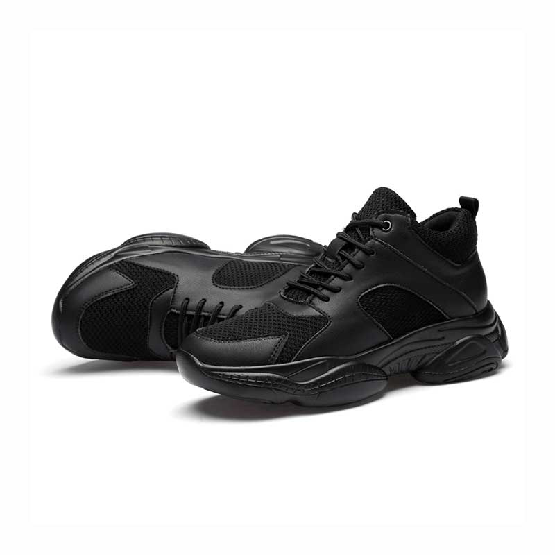 Black athletic style elevator trainers on a white background