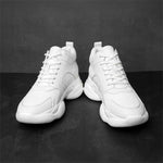 Pair of white high-top elevator sneakers on a dark grey background