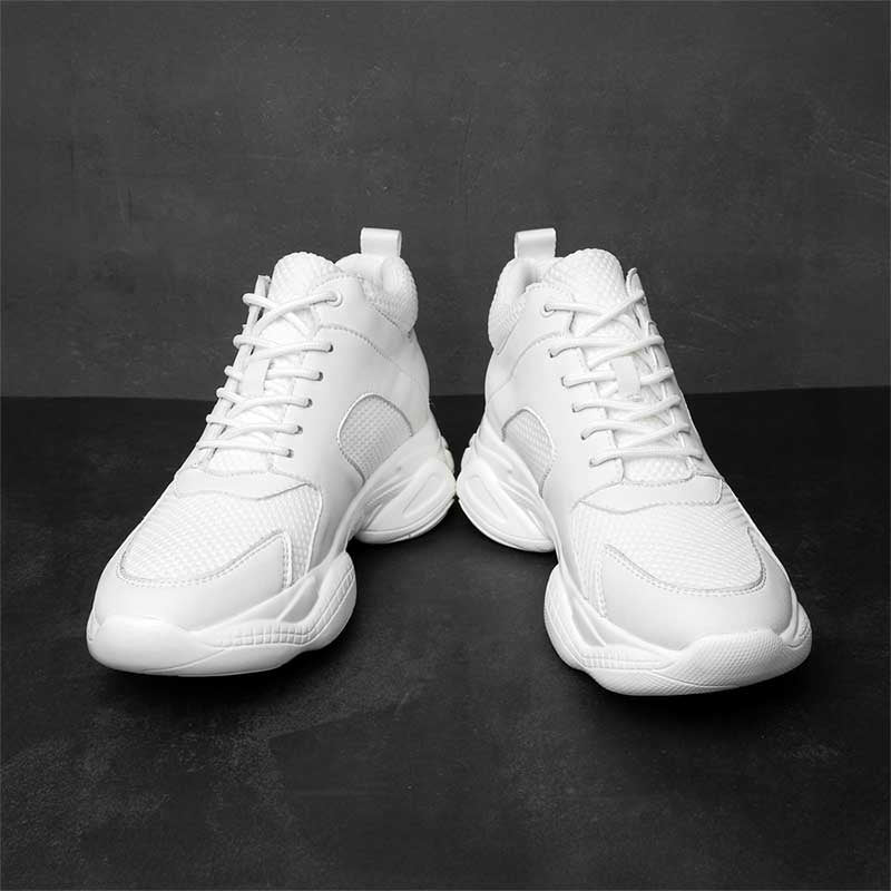 Pair of white high-top elevator sneakers on a dark grey background