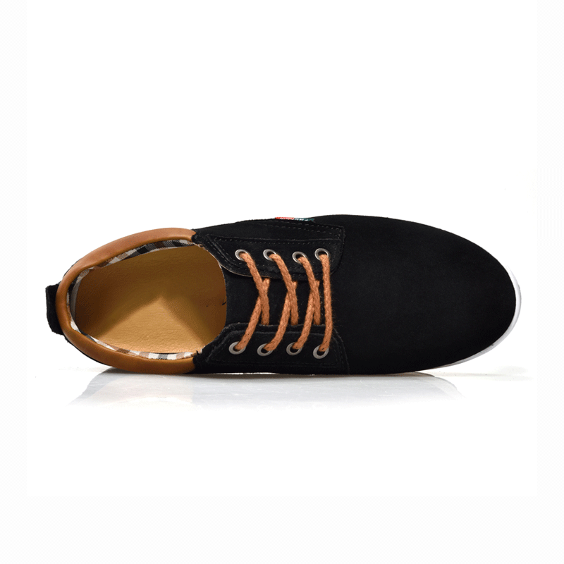 Black sneaker with brown interior on a white background