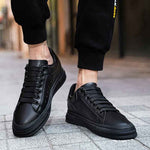 Front close up of black elevator sneakers