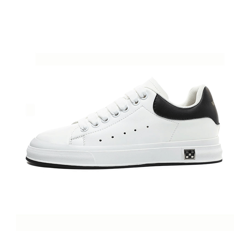 A stylish white sneaker with a black heel cap and sleek design, featuring lace-up closure and perforated detailing on the side.
